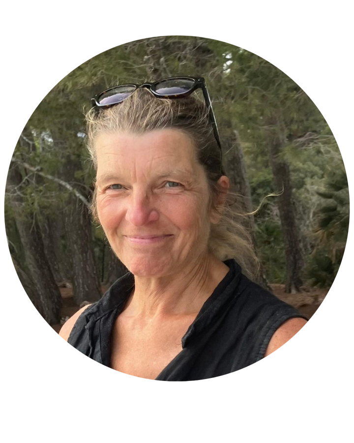 Maria Bauriedl smiling outdoors among pine trees